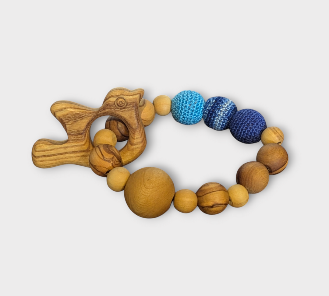 Handmade blue crocheted olive wood teething ring with peace dove
